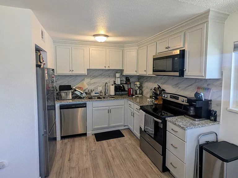 Kitchen with new appliances and ample storage space
