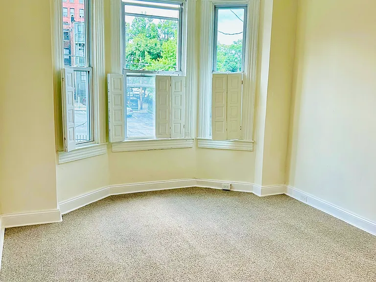 Second bedroom with built-in original shutters from the 1870s, ceiling fan, and closet (not pictured). Also has a deep hall closet.