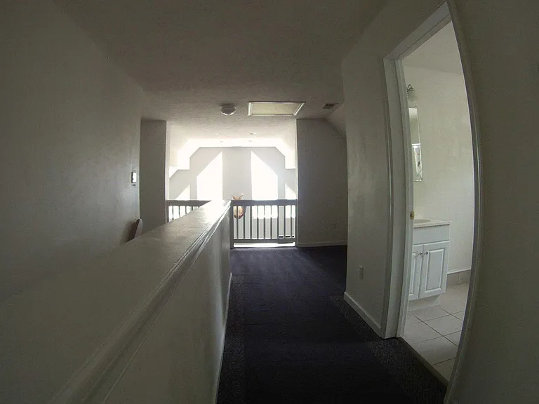 Hallway leading back from Master Suite to lower staircase and landing