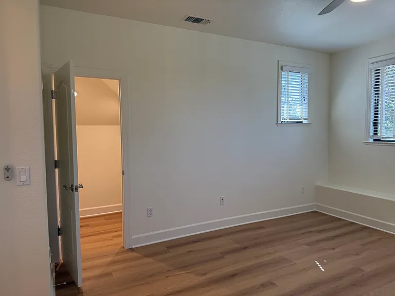 Fourth bedroom is on the third floor with a bathroom across the hallway. The fourth bedroom features a ceiling fan with 2 walk-in closets.
