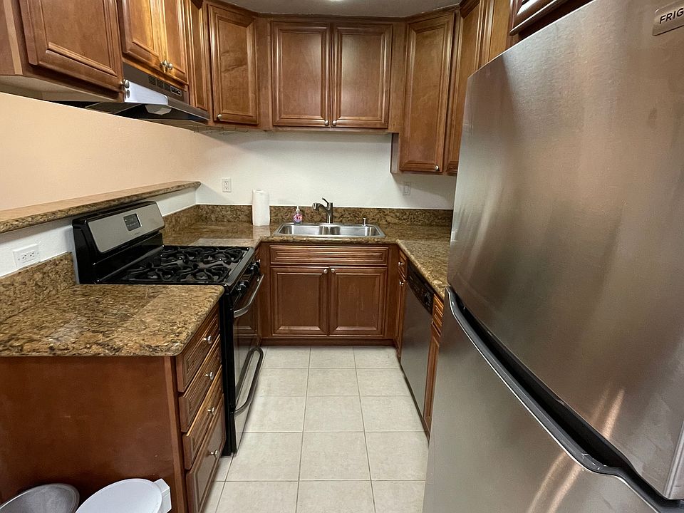 Kitchen with new gas oven/cooktop, refrigerator (2024); microwave and dishwasher.