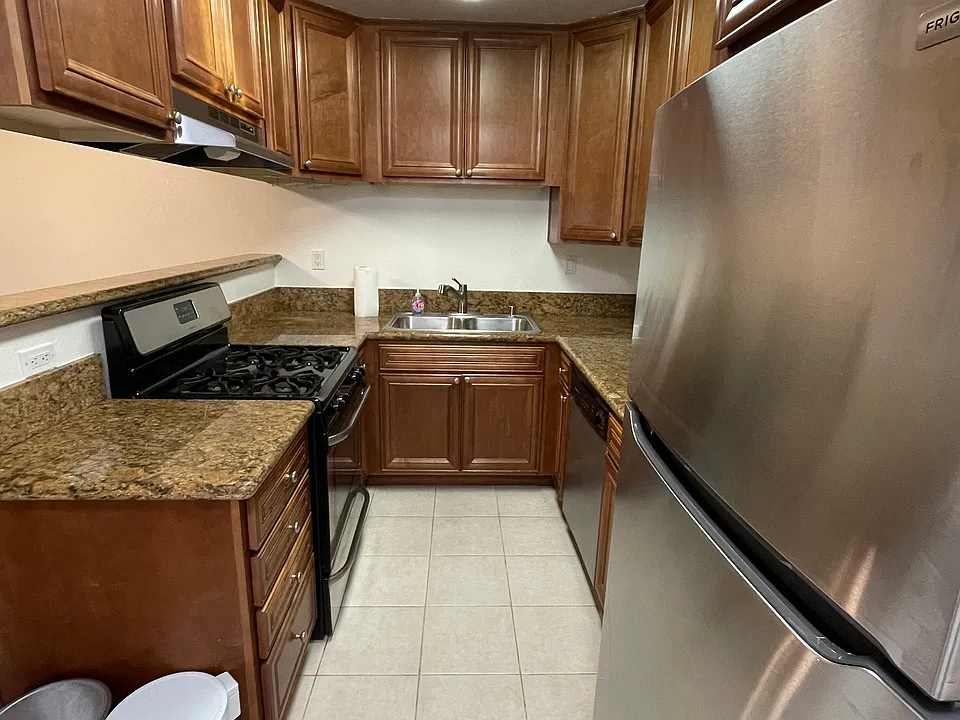 Kitchen with new gas oven/cooktop, refrigerator (2024); microwave and dishwasher.