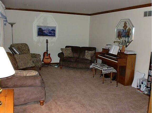 New carpet in living room on left of entry