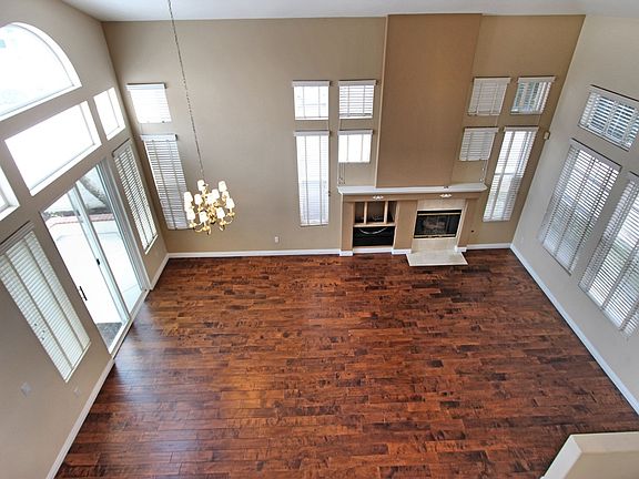 Spacious living and dining room with two story ceilings. Li