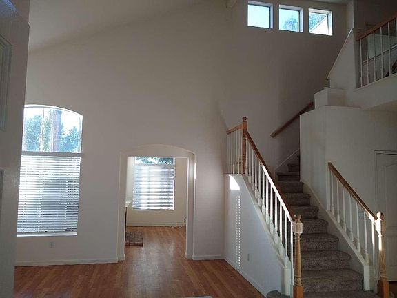 View from entry way; formal living room with soaring ceiling