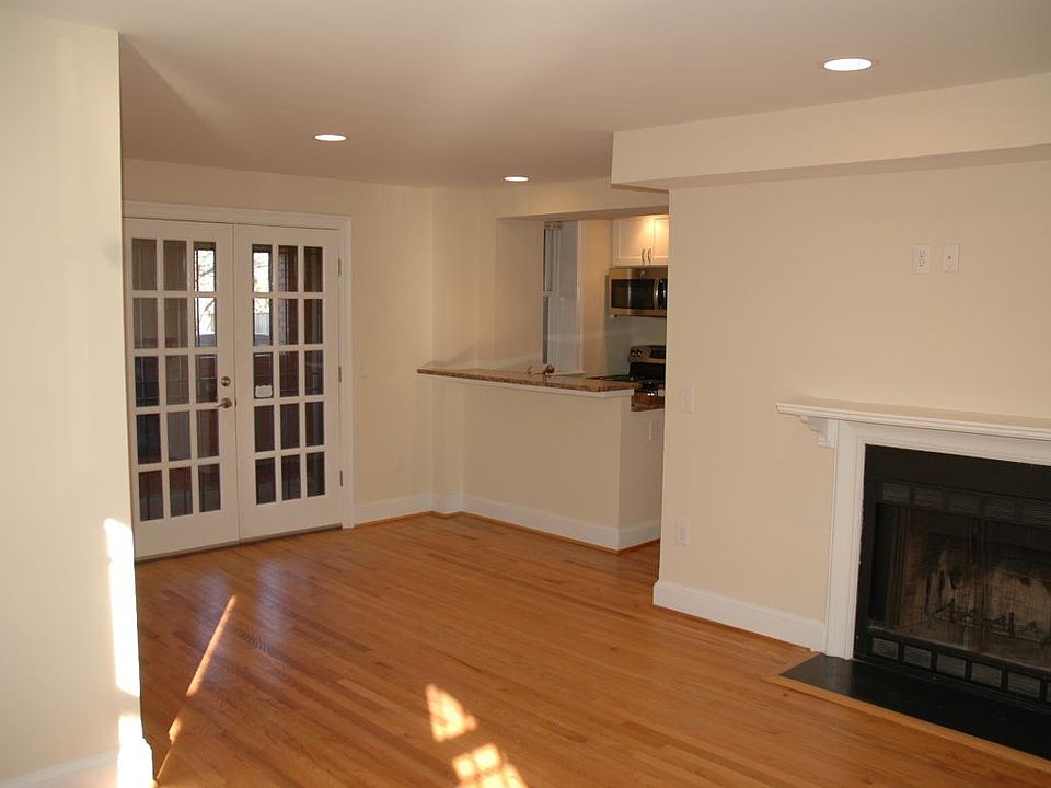 Open living room wid wood burning fire place