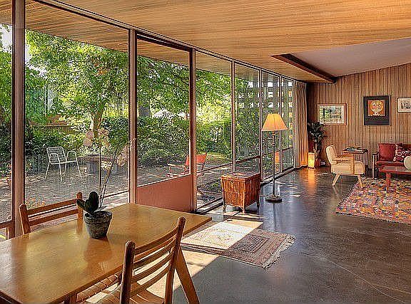 Large living room has passive solar design that lets max light in winter, blocks hot sun in summer