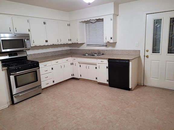 Kitchen with dishwasher & garbage disposal, door to back patio