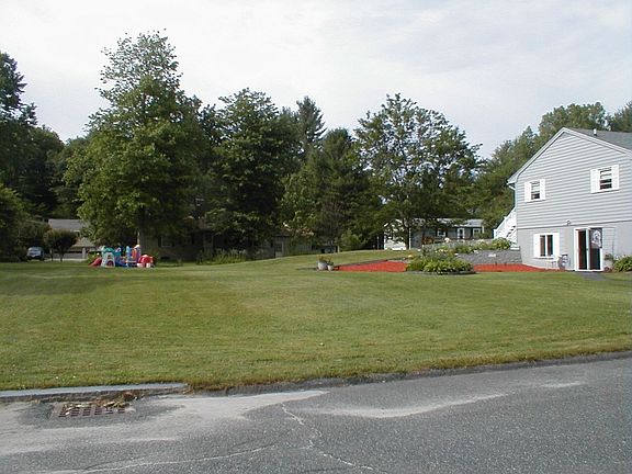 side of house with flower garden by walkway