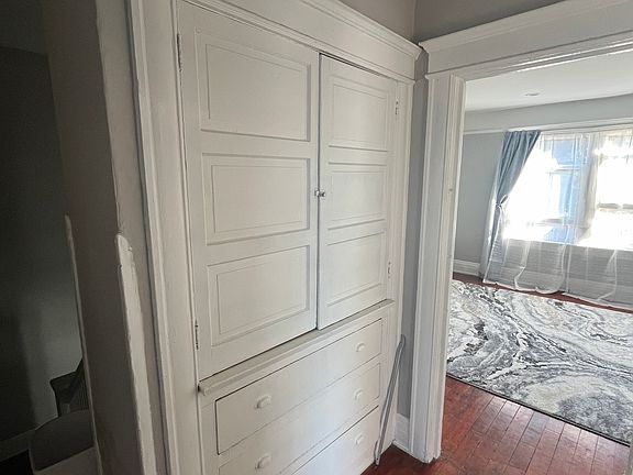 Upstairs hallway with common area linen closet and drawers.