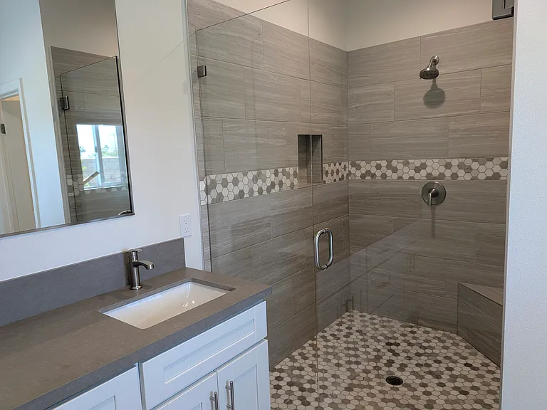 Primary bathroom with huge shower, double vanity and private toilet room