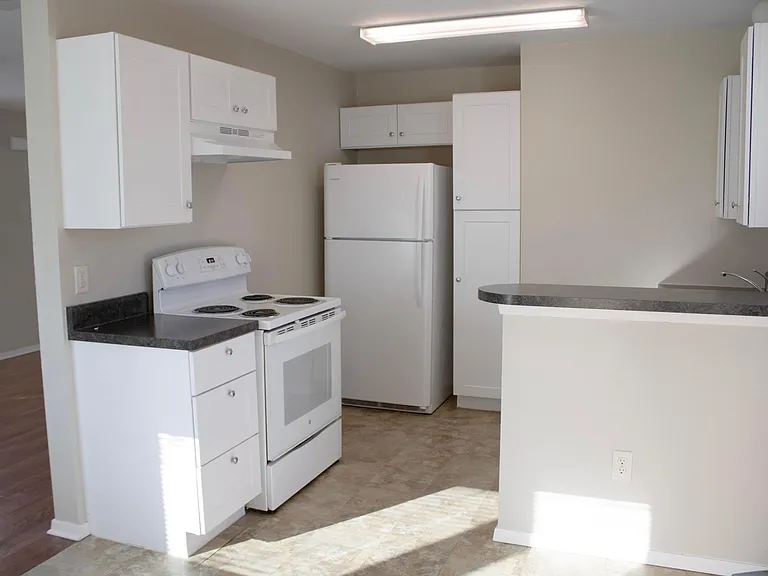 Kitchen with refrigerator, stove