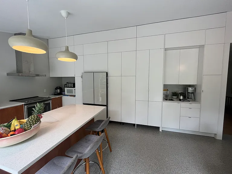 Generous pantry storage floor to ceiling. Beverage station with hot + cold water faucet, sink that doubles as an ice bucket for party time, counter space for coffee maker and wet bar.