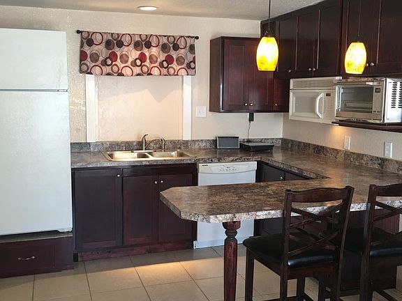 Kitchen with peninsula and bar stools