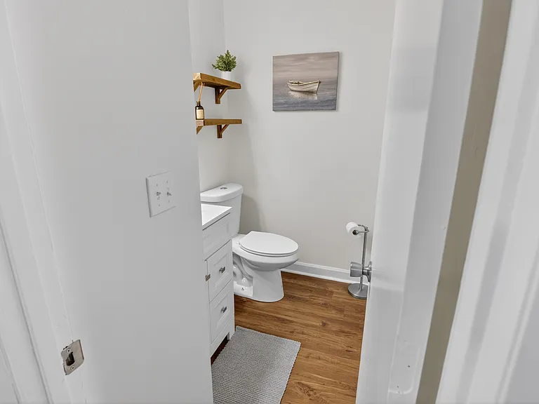 Fully renovated half bath between the living room and kitchen