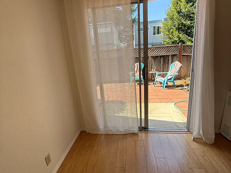 Bedroom downstairs with sliding glass door onto the patio