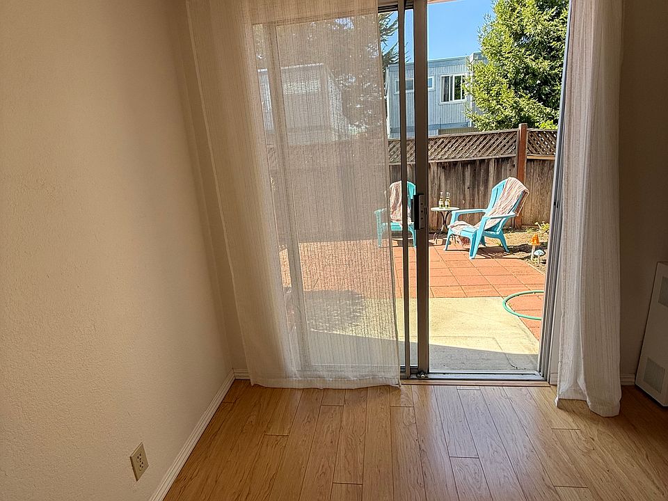 Bedroom downstairs with sliding glass door onto the patio