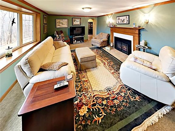 The large living room features a beautiful gas log insert, which provides wonderful warmth in the cooler months.