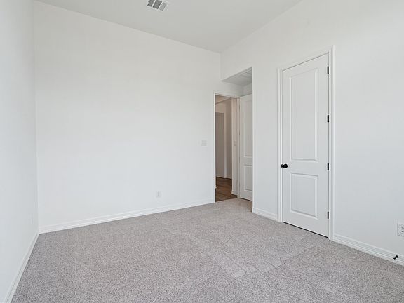 An additional view of the second bedroom and closet.