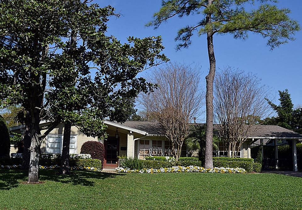 Front Elevation: Inviting curb appeal captured by French 10-lite doors used as windows in the formal