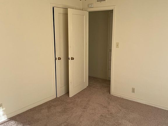 Bed room with closet behind door.