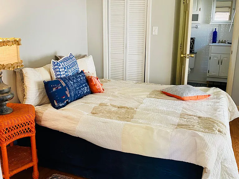 The cozy First bedroom fits a queen bed steps from the bathroom and closet!