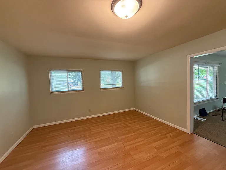 Family room with two windows overlooking Crab Apple St, opening on the right goes to Living room