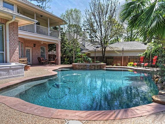 Manicured backyard paradise complete with sparkling saltwater pool & spa with decking & fire pit!