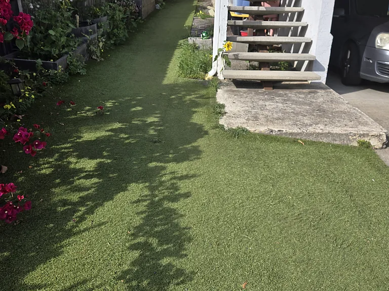 The unit is in front upstairs, on top of the carport parking, and the other unit is behind it. Front yard access for gardening is available, but it must be maintained as well.