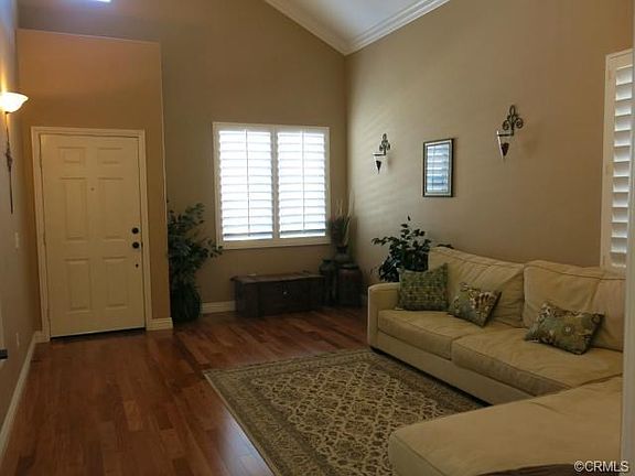 Another side of living room to the Entrance. Crown molding thru-