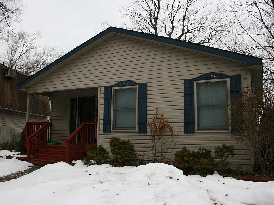 Front of house, more house and lake in back