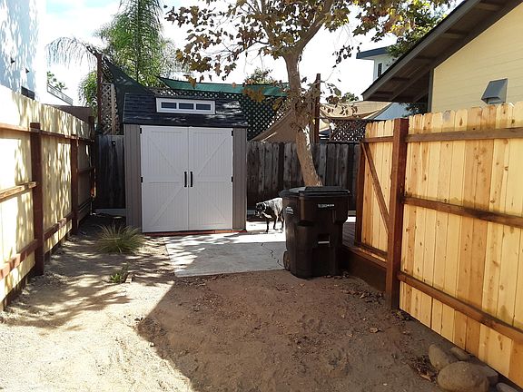 7 foot X 7 foot empty storage shed, located in corner of back yard.
