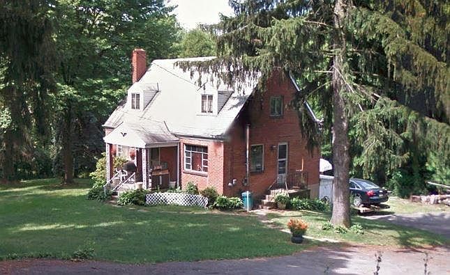 Brick cape cod on large wooded lot