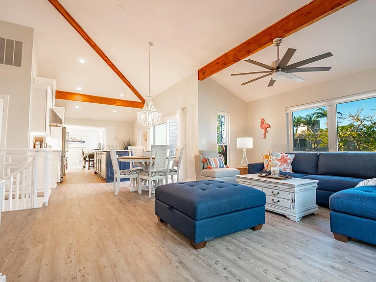 Open living room, dining and kitchen with vaulted ceilings and skylight. Views of the Don Cesar from living room and front deck.