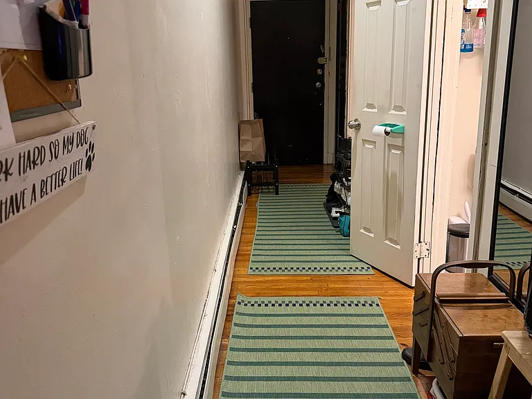 Hallway looking at front door to unit.
