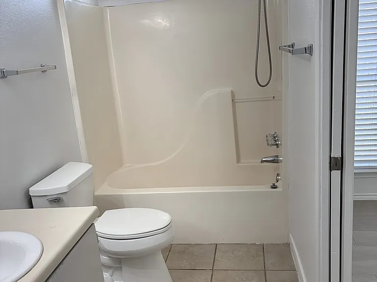 Primary bathroom tub/shower, toilet, sink