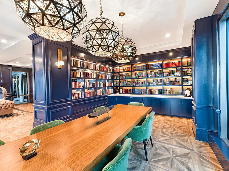 The library at Modera Old Ivy features a polished conference table setting for focused work or intimate gatherings in Atlanta.