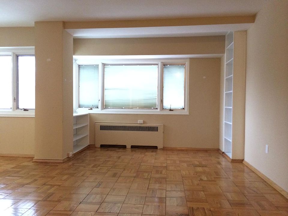 living room with built-in bookshelves and lots of sun