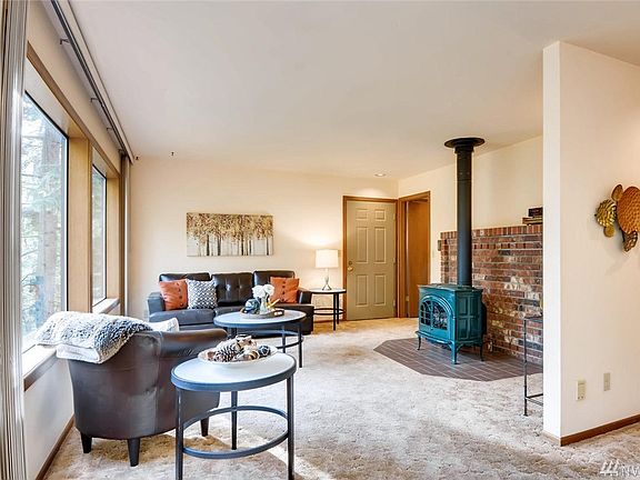 Here's the view of the front door entry.  To the right of the front door is the doorway to the upstairs bedrooms.  The house construction has a cabin feel to it.  The propane standing stove provides a lovely radiant heat throughout the home.