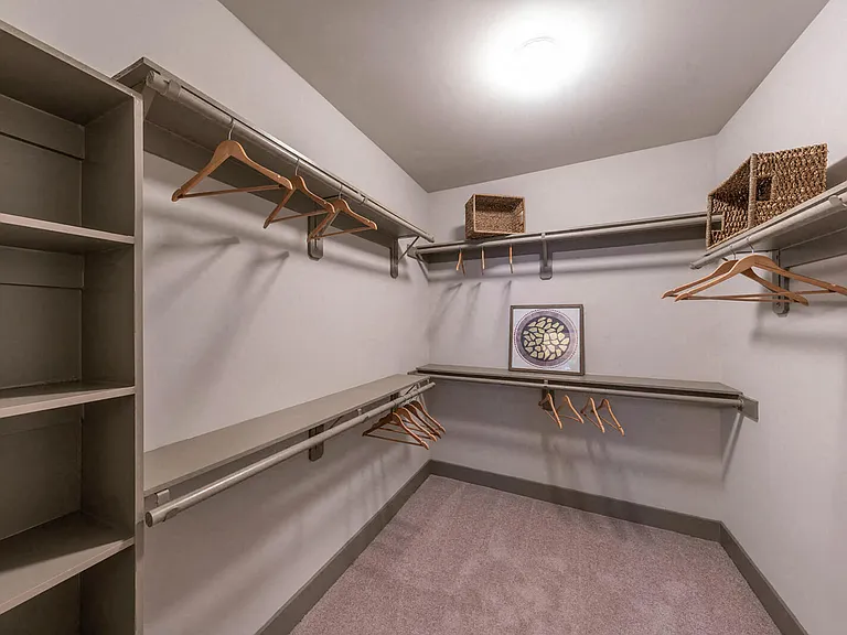 Extravagant walk-in closets with custom wood shelving in select apartment homes