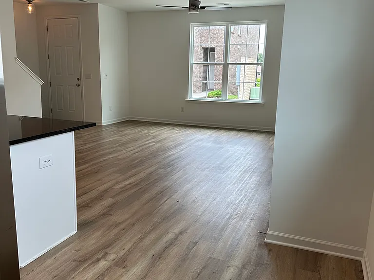 Main level with open space and beautiful wood flooring.