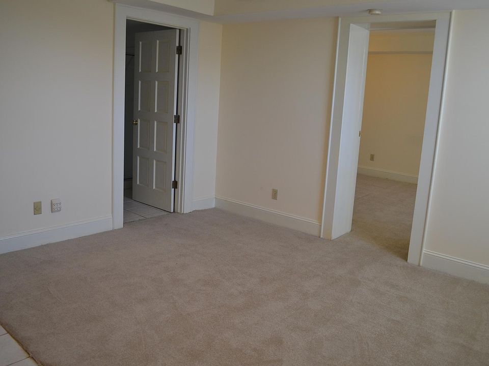 Living area that looks into bathroom on the left and the bedroom on the right.