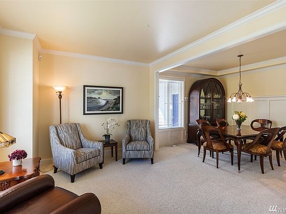 Formal living area leading into formal dining room on the left side of entry