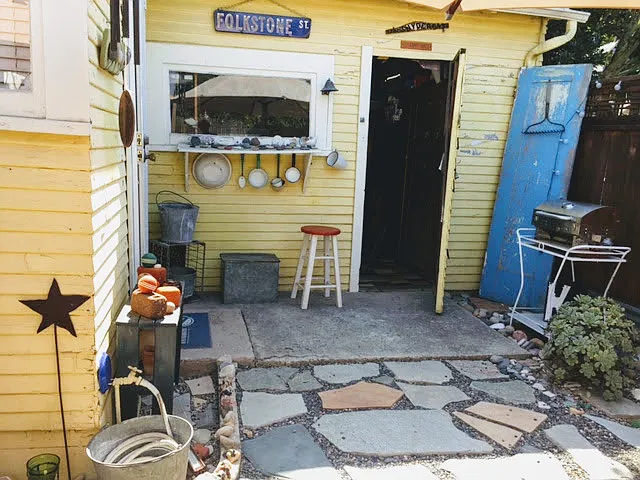 Private enclosed back yard with entrance to storage garage