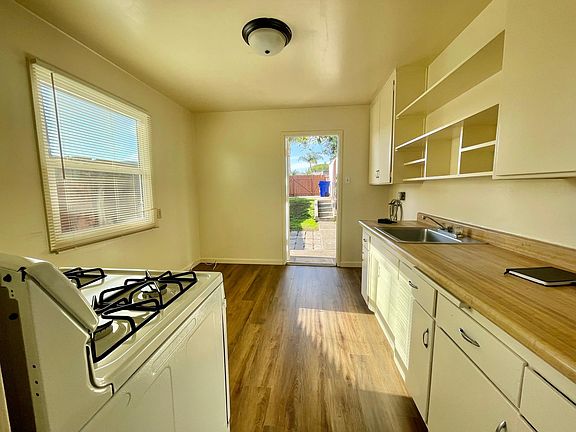 Kitchen opens up to backyard.