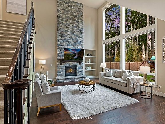 A soaring ceiling and a massive window wall compliment this spectacular family room.