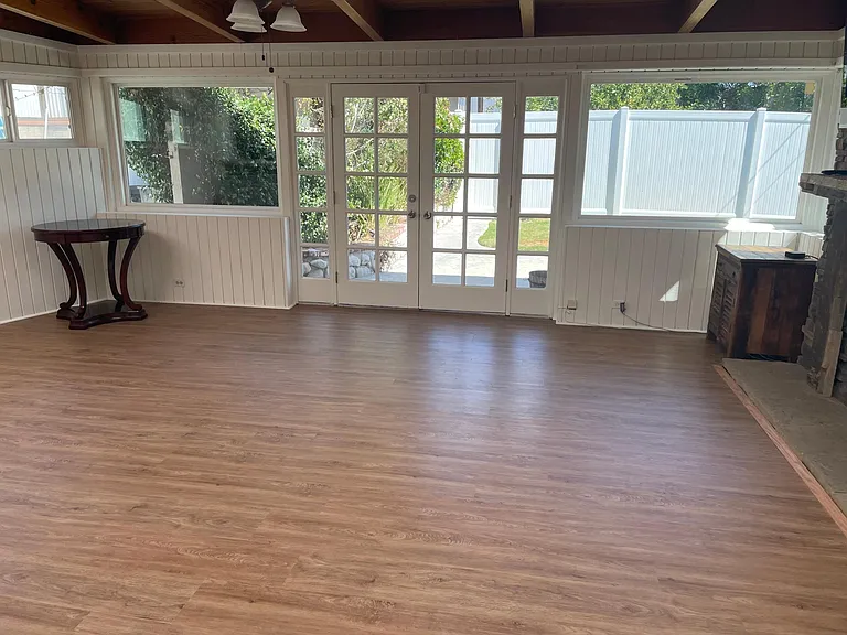 Bonus family/tv room with bar area, wood burning fireplace, sky lights, & French doors