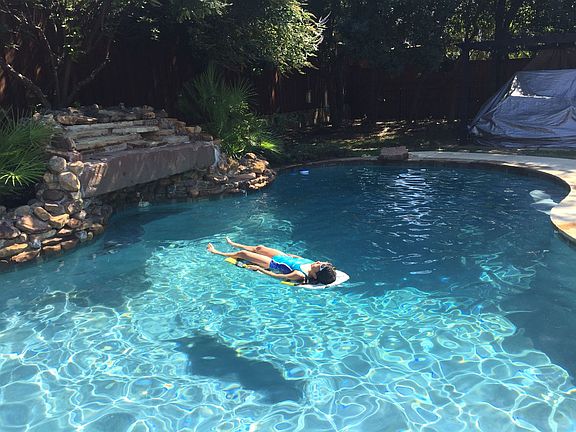 Large oasis swimming pool with waterfall