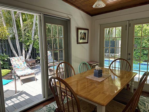 Inside dining table and chairs overlooking the pool