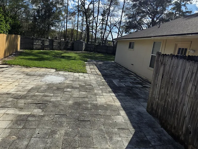 back yard 1/4 acre with new fence, side view from double gate